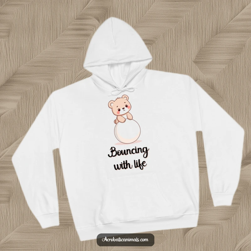 Funny hoodie featuring a little bear cub balancing on a bouncy ball, offering warmth and adorable humor.