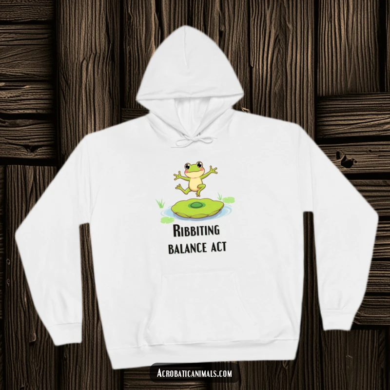 Funny hoodie showcasing a skilled frog character performing an impressive balance act on a spinning lily pad, promoting adventurous humor.