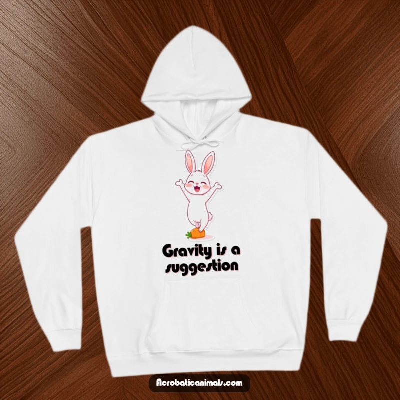 Funny hoodie featuring a delighted rabbit character in a handstand on a small carrot, radiating warmth and whimsical acrobatics.