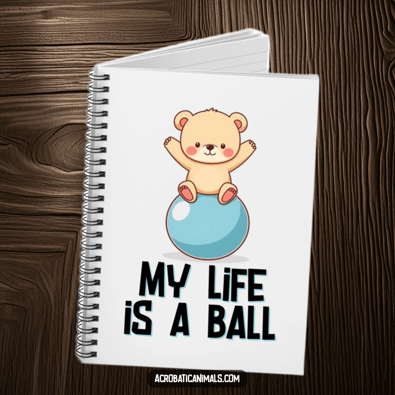 Funny bear cub balancing on a yoga ball featured on a notebook cover, inspiring creativity and amusement for note-takers.