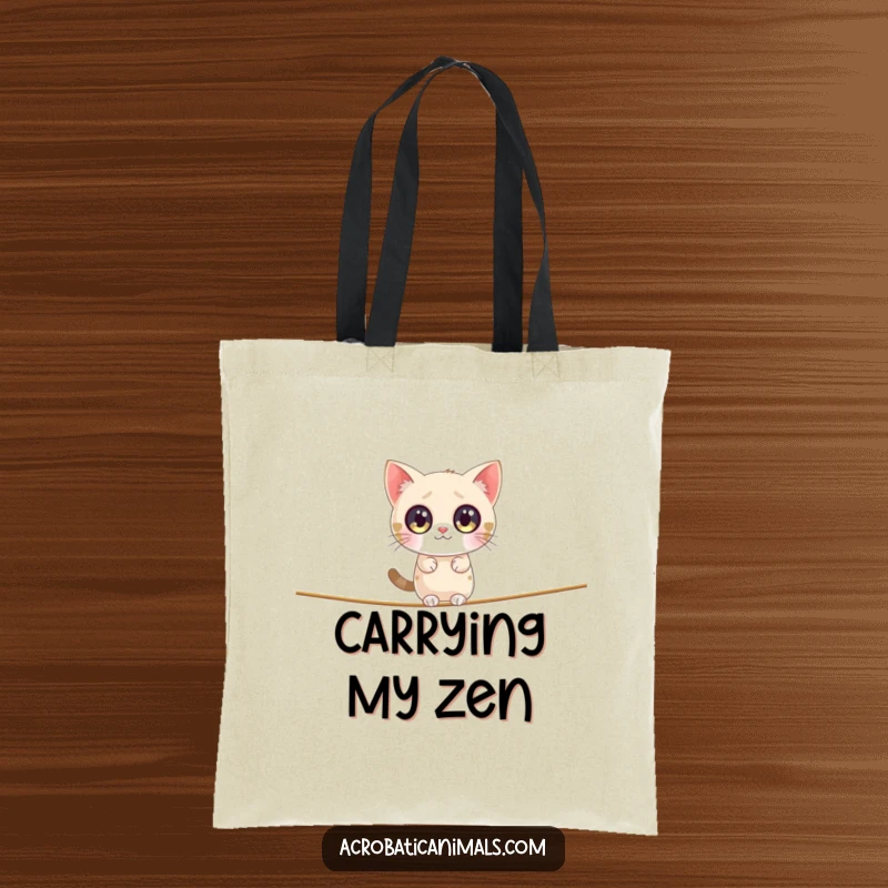 Funny cat tote bag featuring a small, round cat with big, sparkly eyes attempting to balance on a tightrope, very comical.